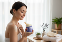 Woman applying Mood Indigo lavender body butter in serene spa setting with fresh lavender and natural light