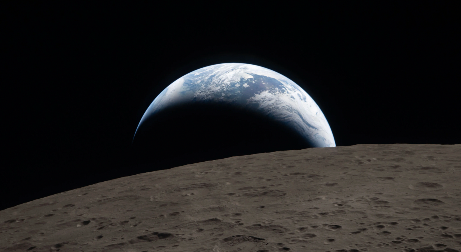 Earthset photographed by NASA's Artemis II crew on April 6, 2026, showing a crescent Earth setting behind the Moon's rugged surface from 252,756 miles away
