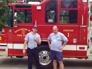 Local firefighters standing in front of the Davidson, North Carolina Fire Department truck.