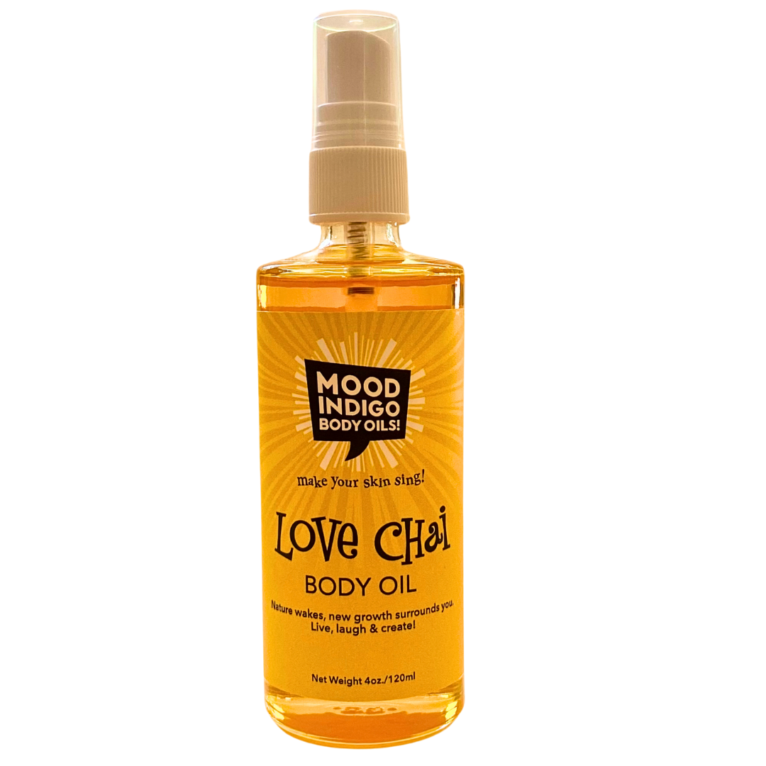 Refreshing, lightweight moisturizer. Lemongrass Body Oil for dry skin, in a glass bottle with a yellow label. Label has Mood Indigo logo in black ad product name Love chai. handcrafted in Davidson, NC