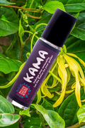 Exotic Kama essential oil roll on perfume bottle with ylang ylang flowers and leaves in the background. Made by Mood Indigo apothecary