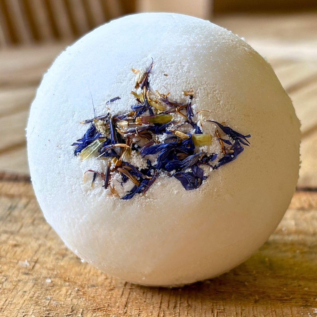 Moisturizing Lavender bath bomb with dried flowers on a wooden surface by Mood Indigo 