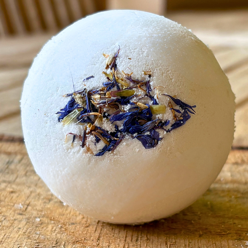 Moisturizing Lavender bath bomb with dried flowers on a wooden surface by Mood Indigo 
