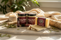Patchouli Essentials Bundle 6-piece self-care set arranged on natural wood surface with dried patchouli leaves, candles, and soft textiles in a spa-inspired bohemian luxury setting