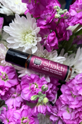 Patchouli essential oil perfume from Mood Indigo on a bed of pink and white flowers