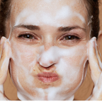 Woman washing her face with Rose Face soap by mood Indigo