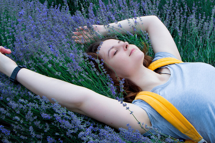 young woman laying in a field of lavender