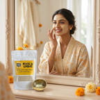 Indian bride applying a clay face mask beside a Mood Indigo Rise & Shine pouch and brass mixing bowl on a sunlit vanity.