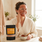 Woman applying a reddish-brown Mango Mamma clay mask