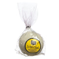 A lemongrass bath bomb from the 'LOVE CHAI' line, packaged in a clear plastic wrap with a yellow label featuring floral patterns.